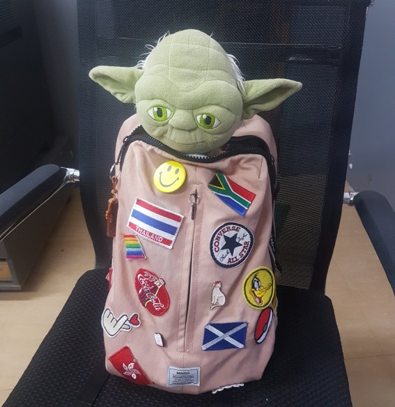 School bag with yoda doll inside
